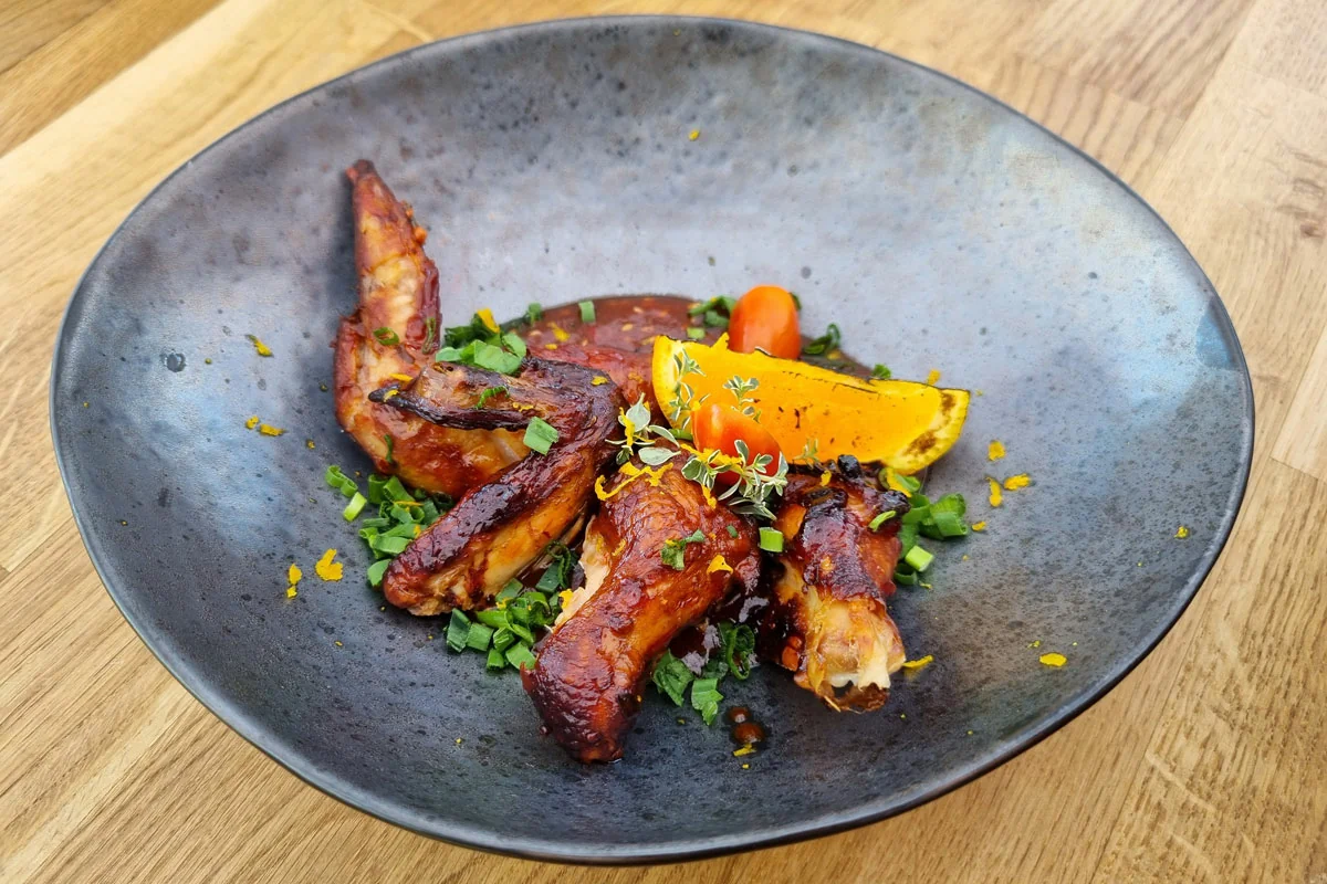 Finished glazed smoked chicken wings served on a plate